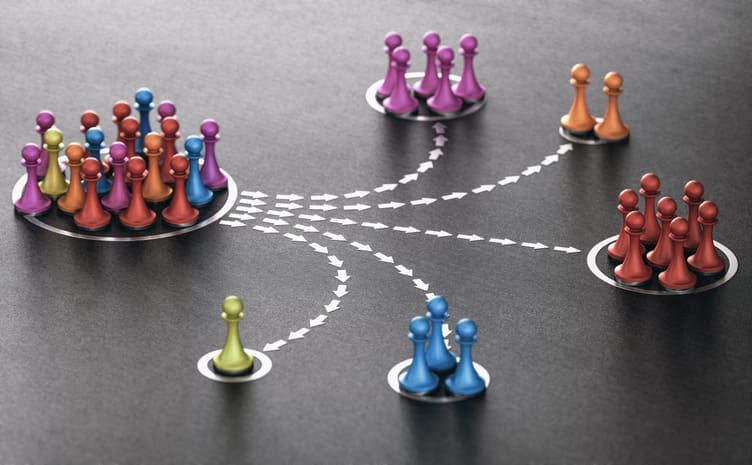Different colored chess pawns put into groups by color