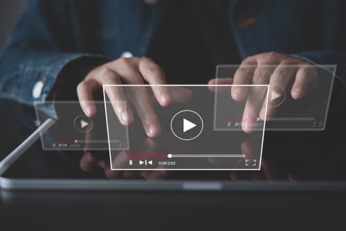 A business owner working on creating a video on a laptop