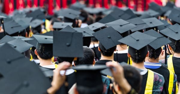 The backs of several students at graduation