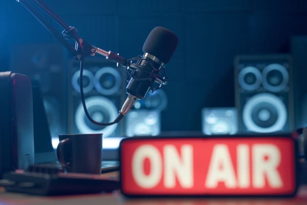 A radio studio with an "On Air" sign